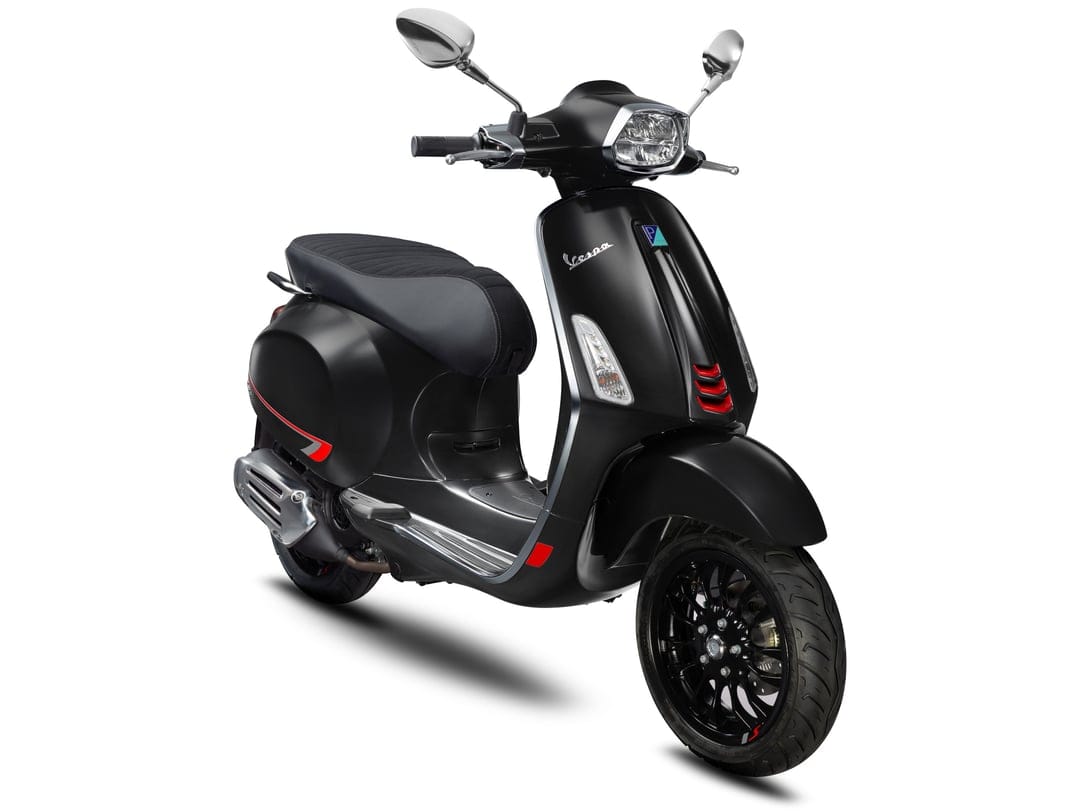 Matte black Vespa Sprint S scooter with red accents and chrome mirrors isolated on a clean white background.