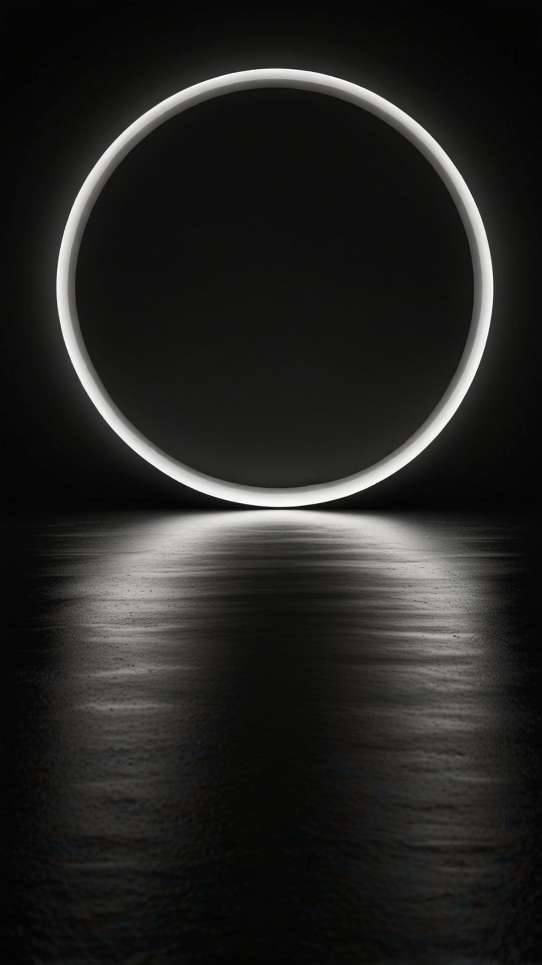 Luminous white ring light reflecting on a dark damp floor against a pitch black background in high contrast.