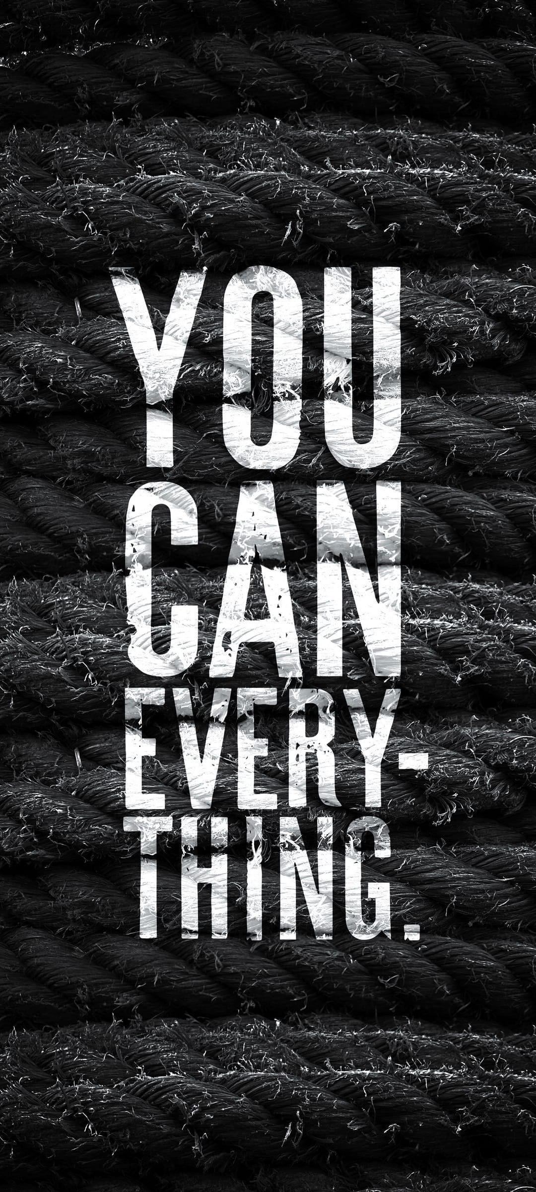 White distressed letters spelling You Can Everything on a dark background of thick, coarse braided hemp ropes.