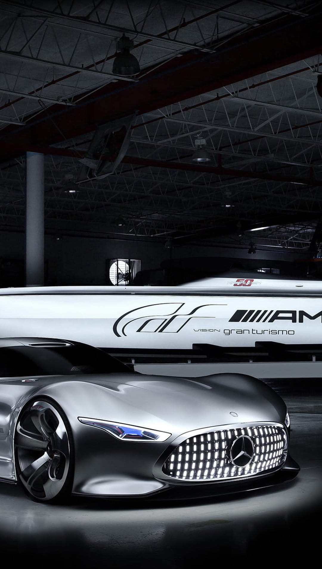 Mercedes-Benz Vision Gran Turismo concept car features a silver body, blue LED headlights, and aggressive grille.
