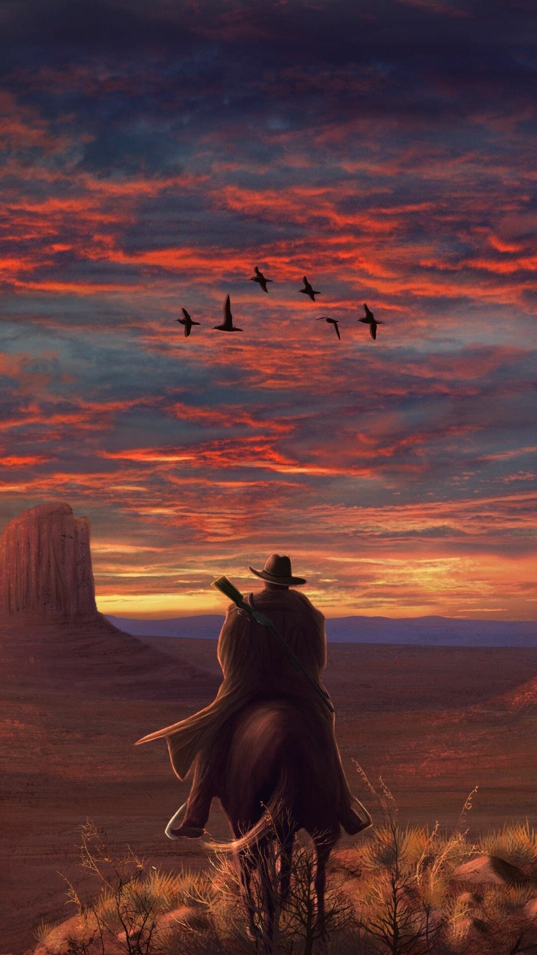 Cowboy on horseback riding toward a mesa under a dramatic red and orange sunset sky with flying birds.