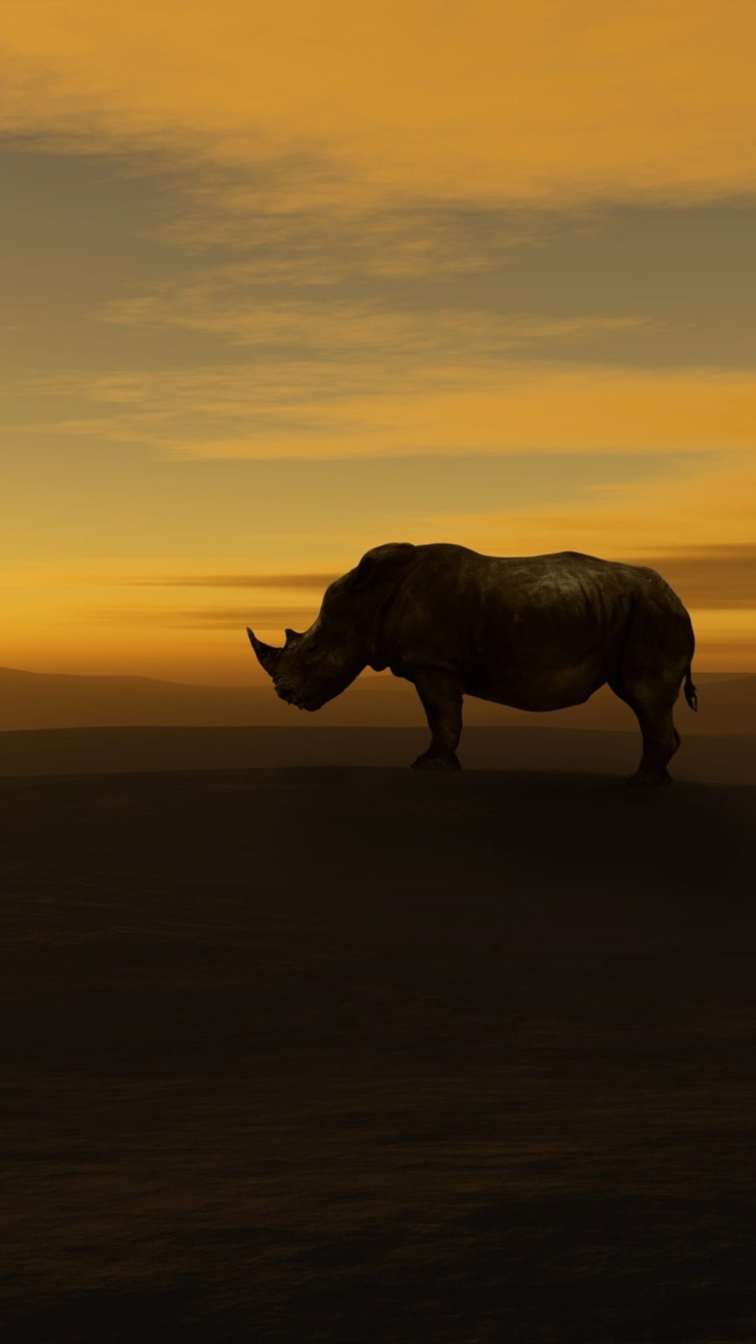 Rhinoceros silhouette standing on a flat savanna horizon under a vibrant orange and yellow gradient sunset sky.