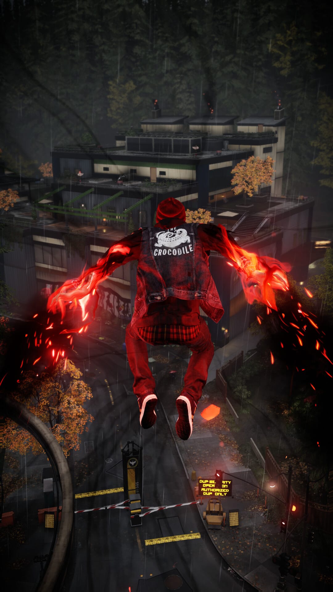 Delsin Rowe jumping with glowing red smoke hands over a rainy city street and a modern building background.