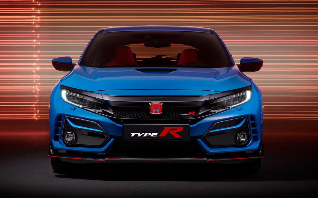 Frontal view of a blue Honda Civic Type R with red badges against horizontal orange light streaks.