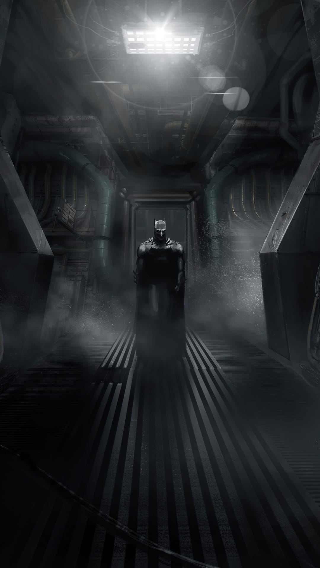 Batman stands stoically in a foggy industrial corridor with overhead light casting long shadows on the floor.
