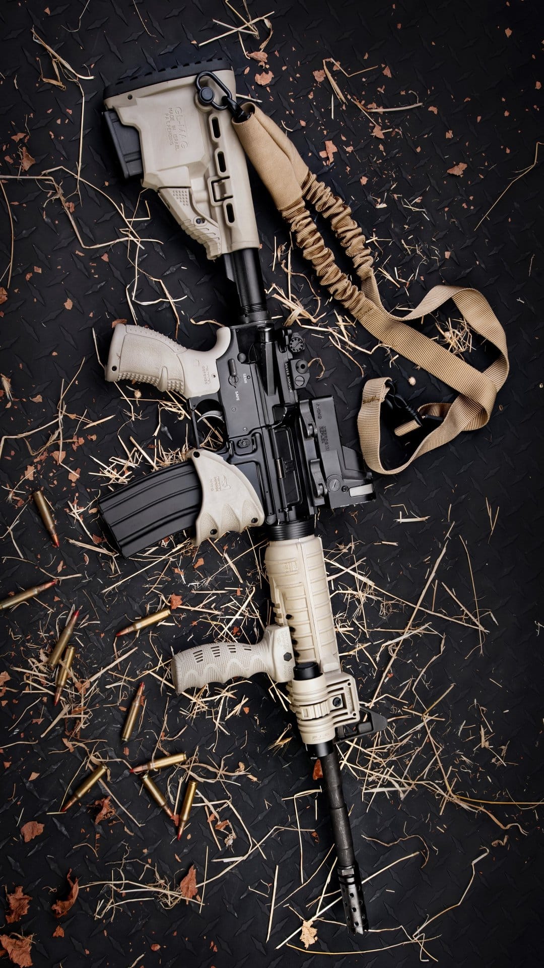 Tan tactical rifle with a black magazine sits near scattered ammunition cartridges on a textured dark background.