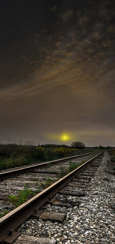 Railroad, tracks, moody, sunset, sunrise, hazy, atmospheric, nature, landscape, travel, journey, solitude, golden light, cloudy, dramatic, wilderness, rural, transport, outdoor, serene
