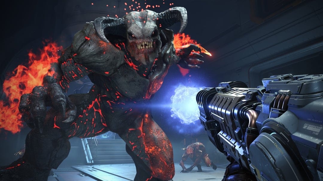A large horned demon with glowing molten skin faces a plasma rifle blast in a dark industrial corridor.