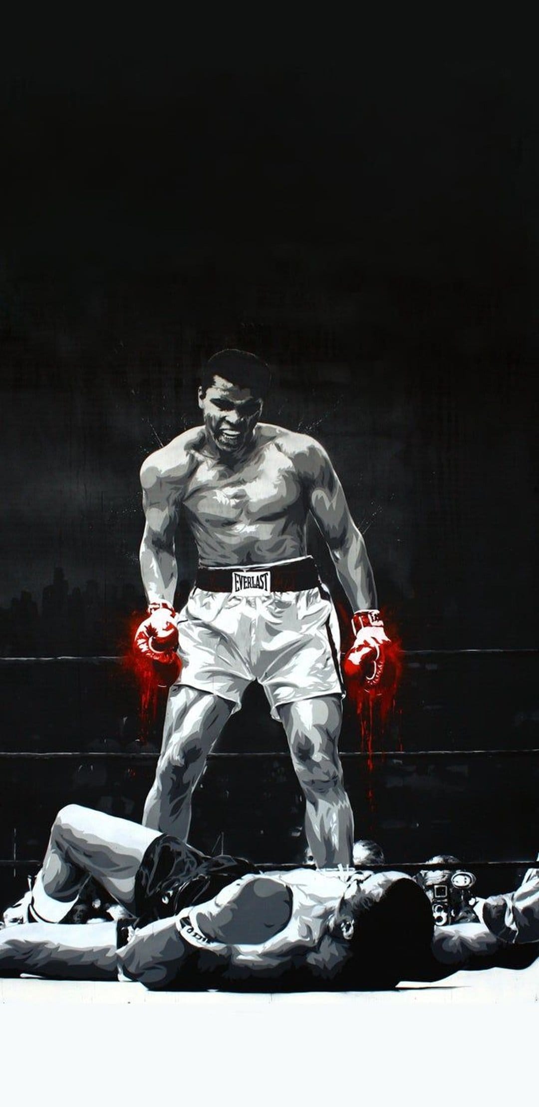 Boxer wearing red gloves stands over a defeated man on a ring mat against a dark urban city background.