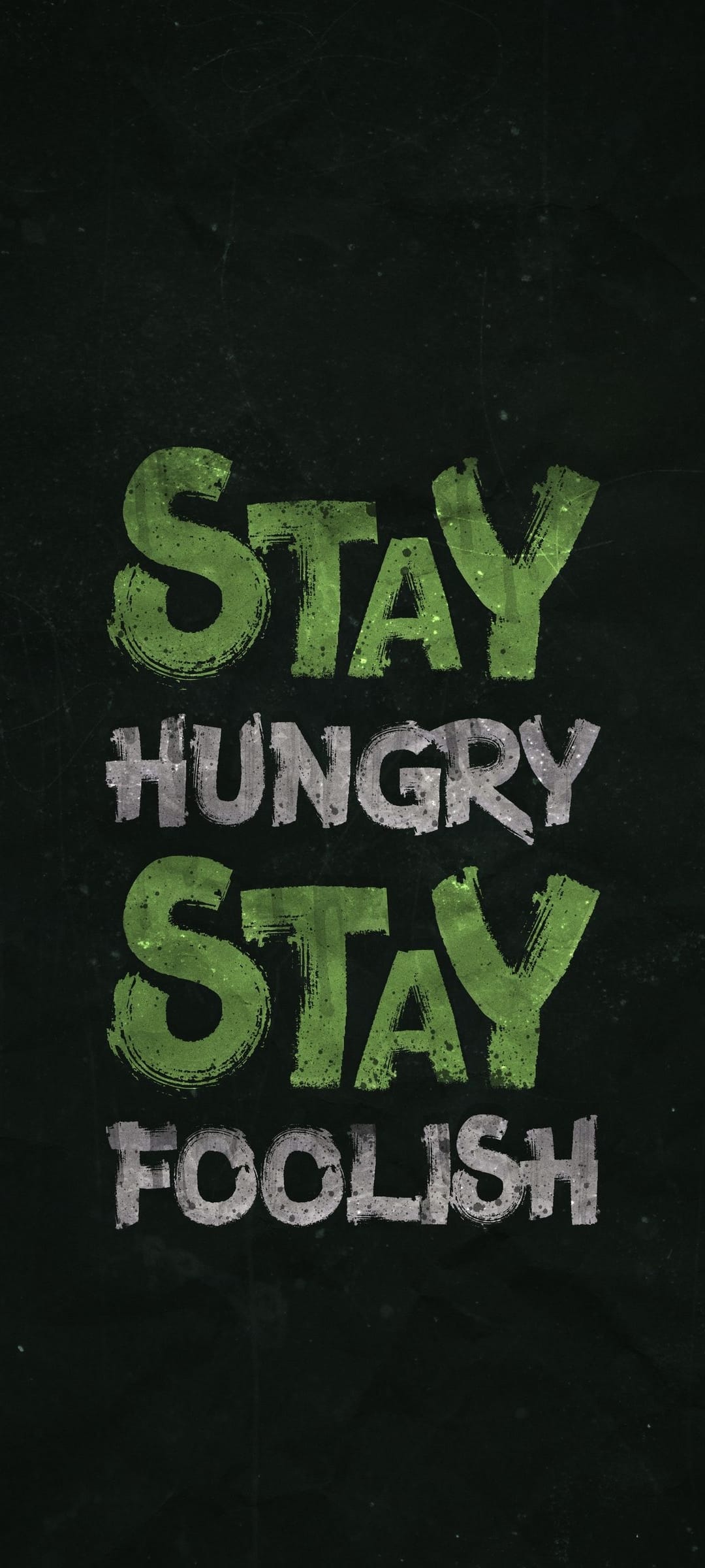 Stay Hungry Stay Foolish quote in weathered green and grey letters centered on a dark textured background.