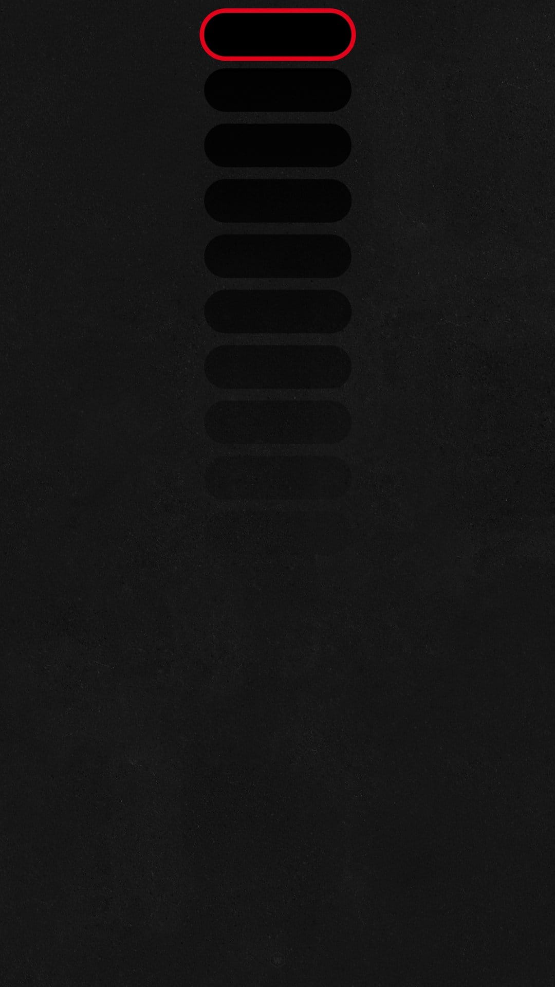 Red glowing oval outline highlights the top button of a vertical stack against a dark, textured black background.