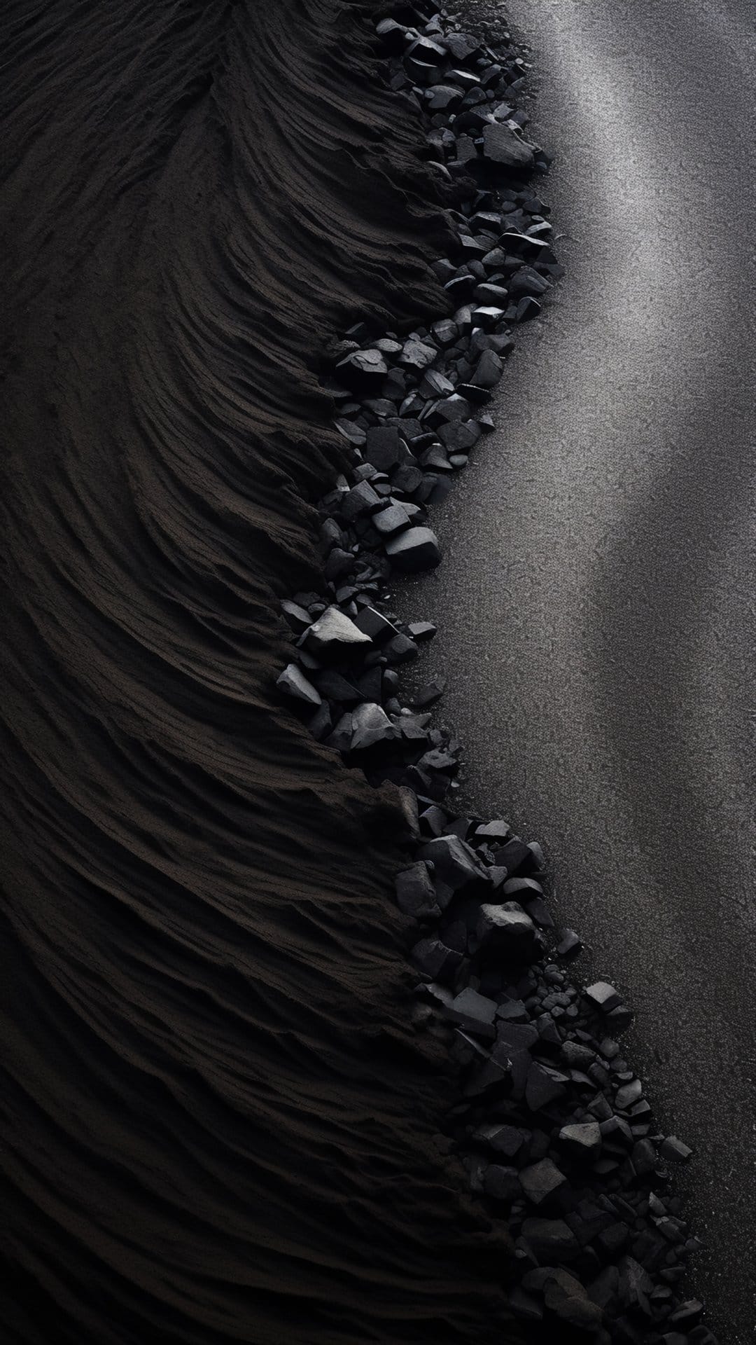 Dark wavy sand dunes weave between sharp black rocks in a high-contrast top-down geological landscape.