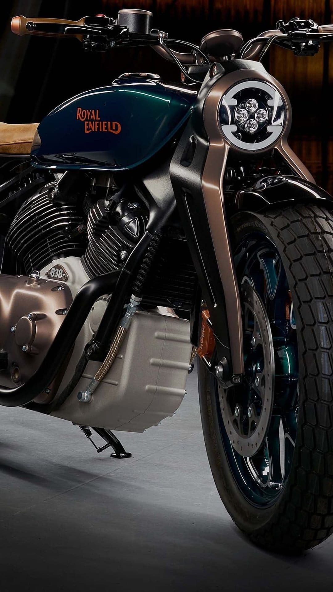 Royal Enfield Meteor 350 motorcycle features a teal tank, circular LED headlight, and polished chrome engine parts.
