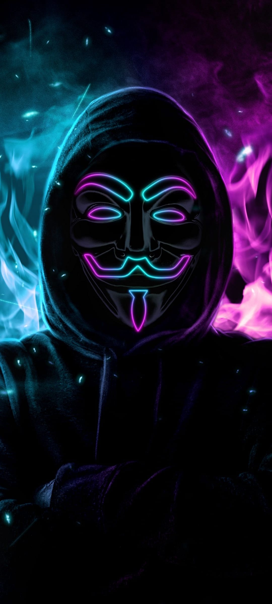 Hooded figure wearing a Guy Fawkes mask glowing with blue and pink neon light against a smoky dark background.