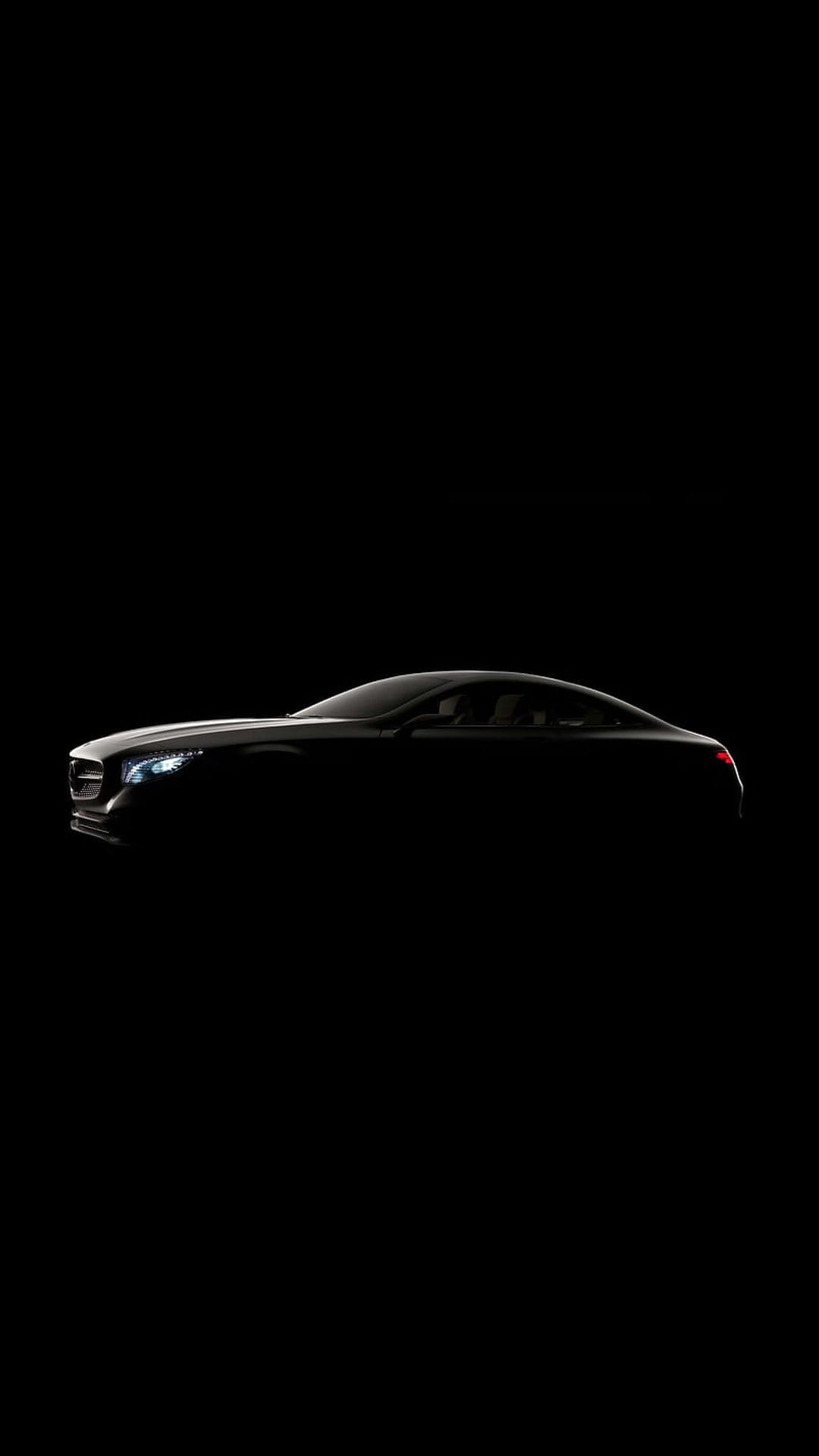 Luxury sports coupe silhouette with glowing headlights against a black background in a vertical minimalist style.