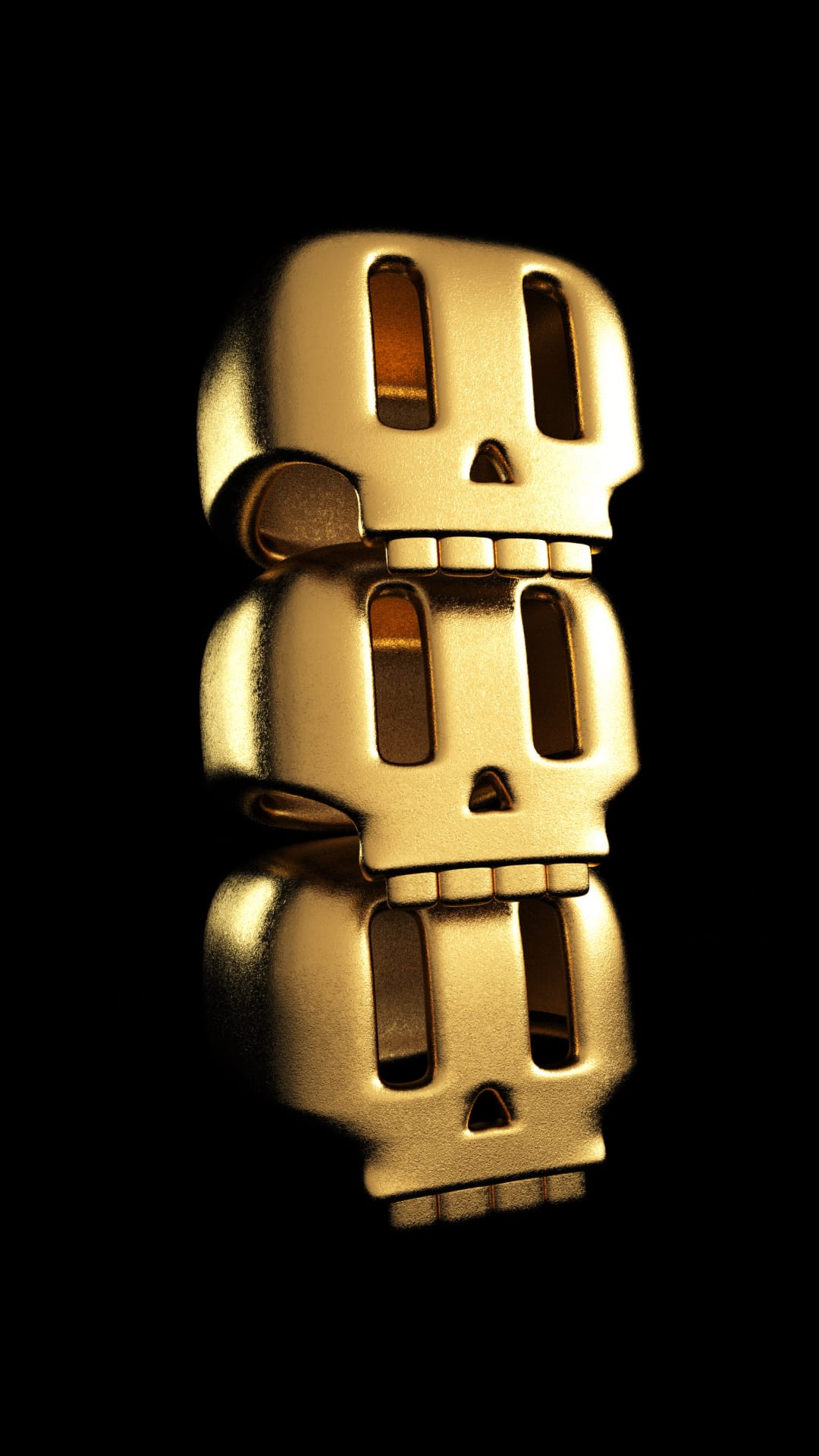 Three stacked gold skull charms featuring hollow eye sockets reflect soft light against a solid black backdrop.