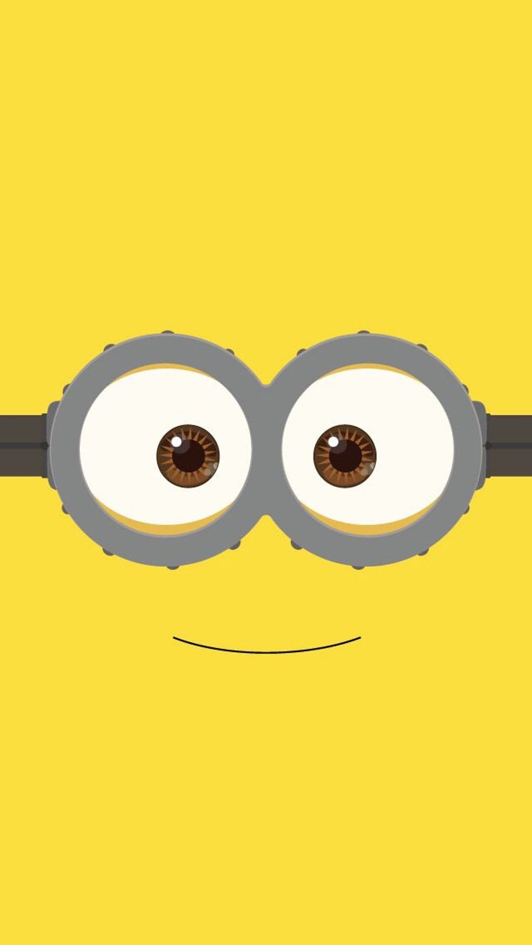 Minion with silver goggles and a small smirk centered on a solid yellow background for a vertical screen display.