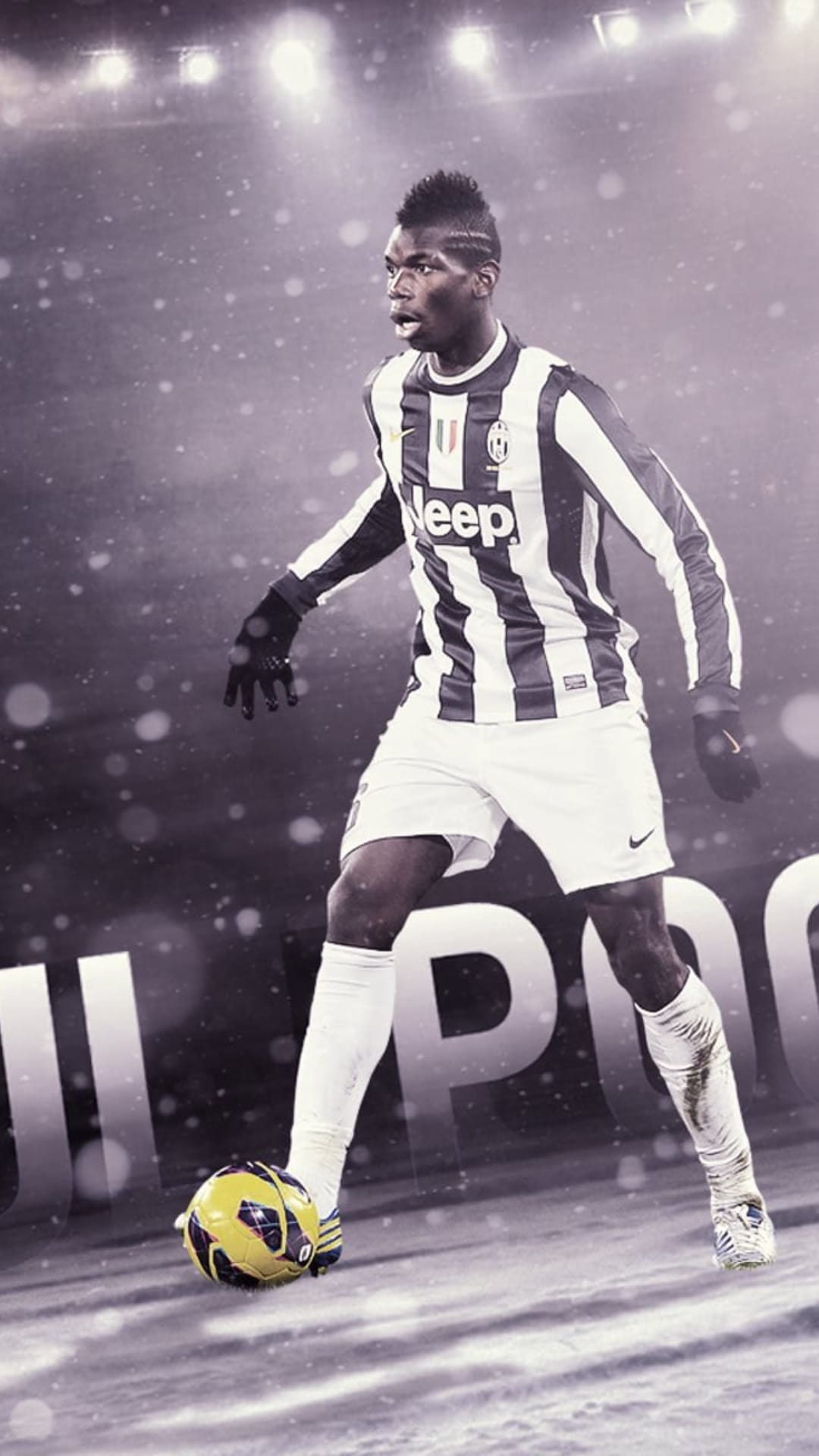 Paul Pogba wearing a black and white Juventus kit controls a soccer ball while large snowflakes fall around him.