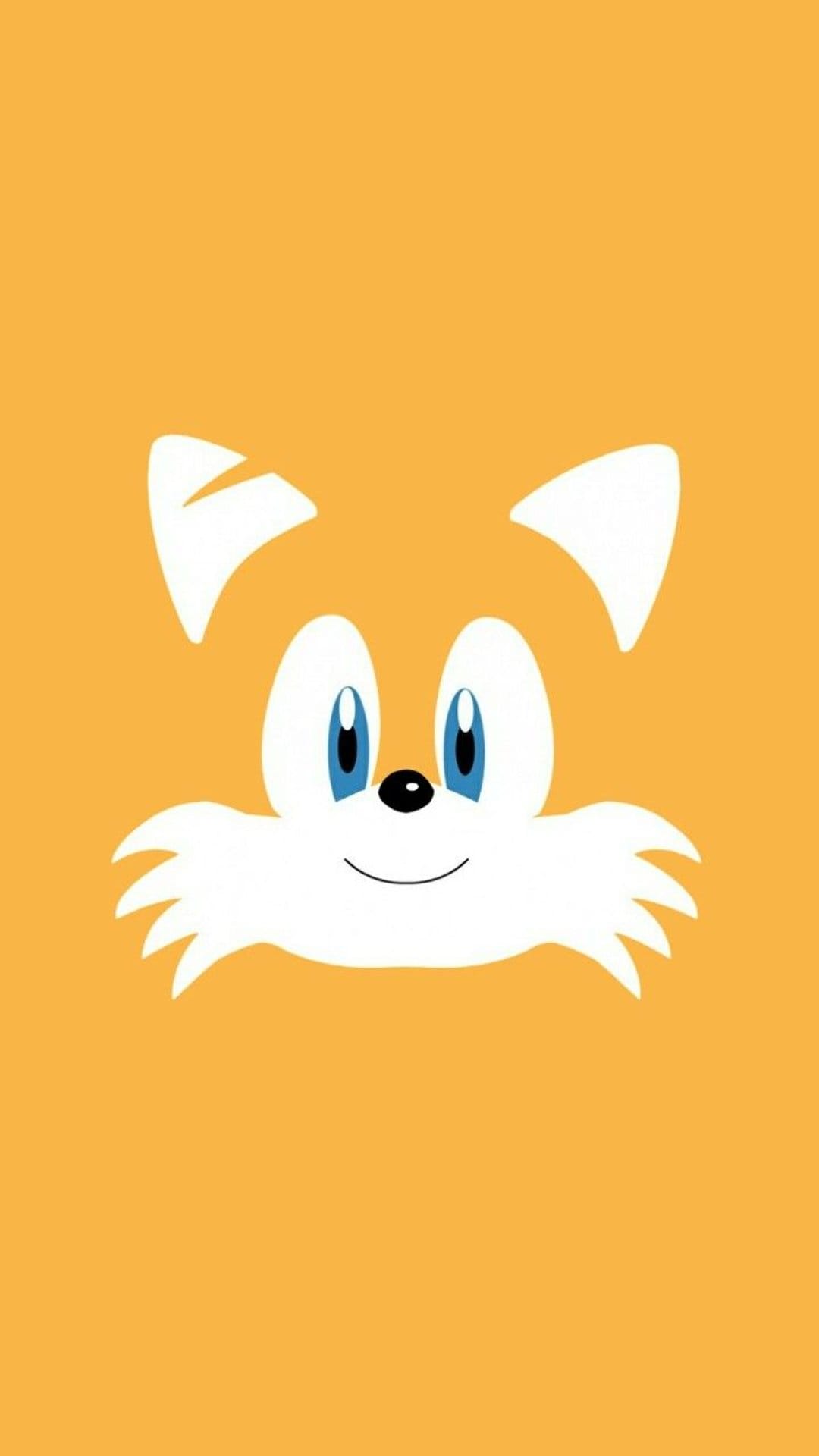 Tails the fox shows a cheerful smile and blue eyes centered on a vibrant orange background for mobile screens.