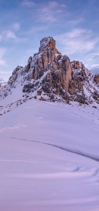 Dolomites, Italy, winter landscape, snowy mountains, Passo Giau, alpine, tranquil, majestic peaks, road, cold, untouched snow, mountain pass, European Alps, serene, scenic, nature, outdoor, travel, remote, sky