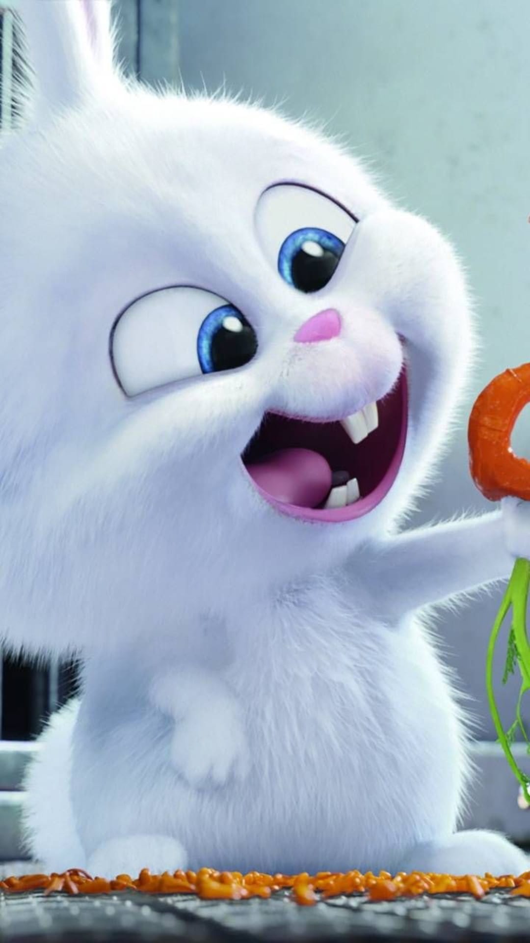 White bunny with blue eyes holds a green-topped carrot while sitting among orange vegetable pieces on a grate.