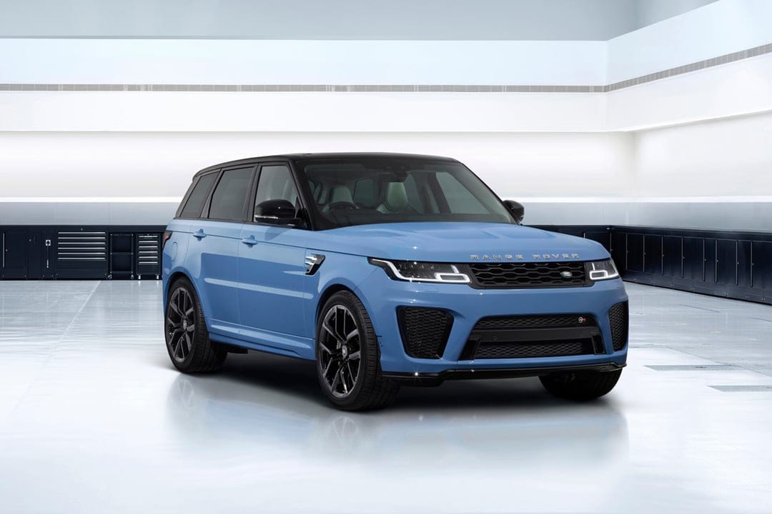 Light blue Range Rover Sport SVR with black roof parked in a bright white minimalist garage with soft lighting.