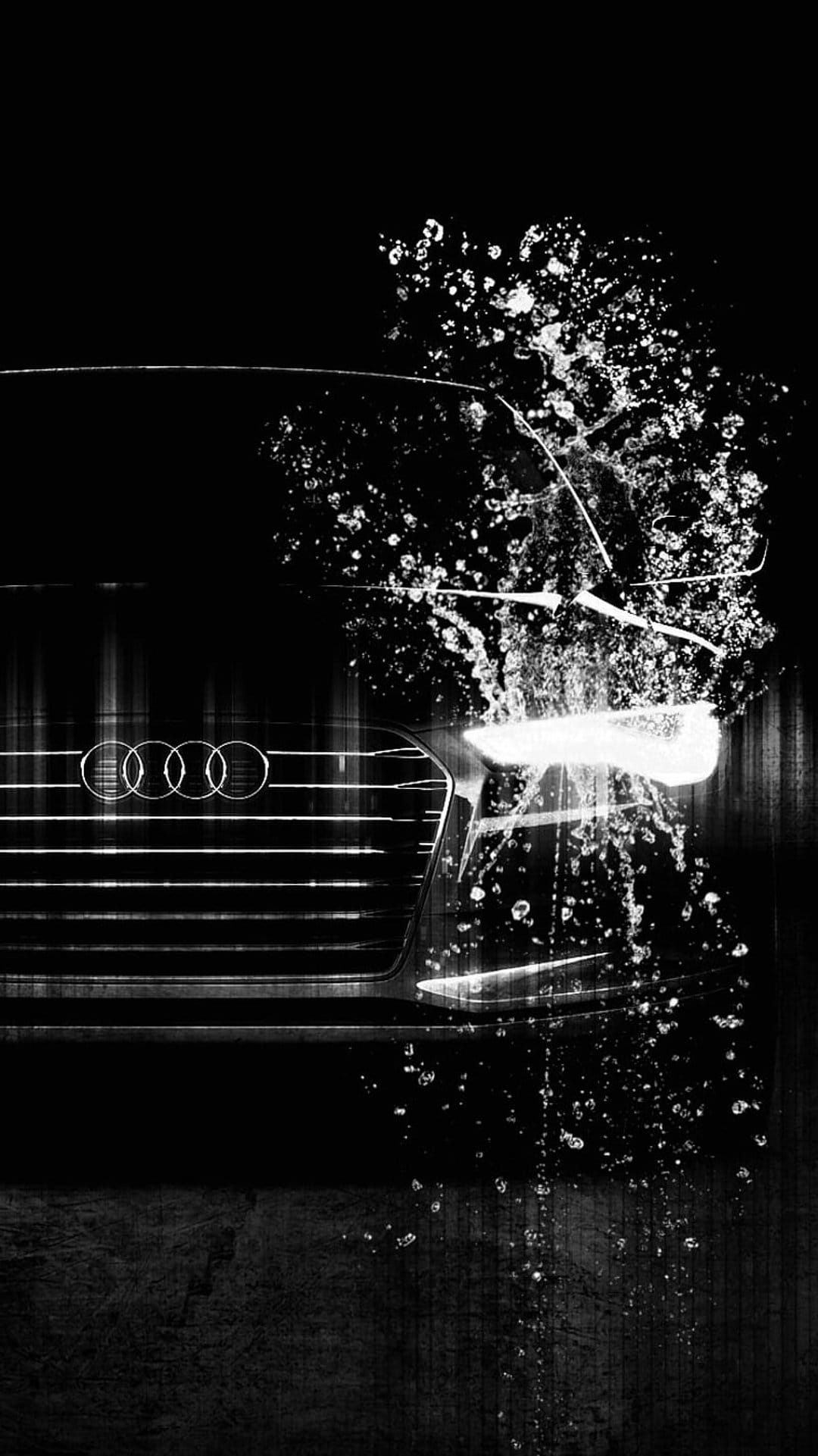 Audi four-ring emblem on a honeycomb grille with sharp water splashes and droplets in high-contrast monochrome.