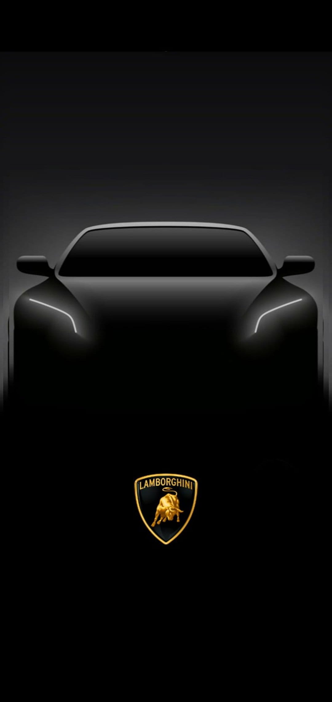 Gold Lamborghini bull crest centered below a shadowed car silhouette with glowing white headlights on black.