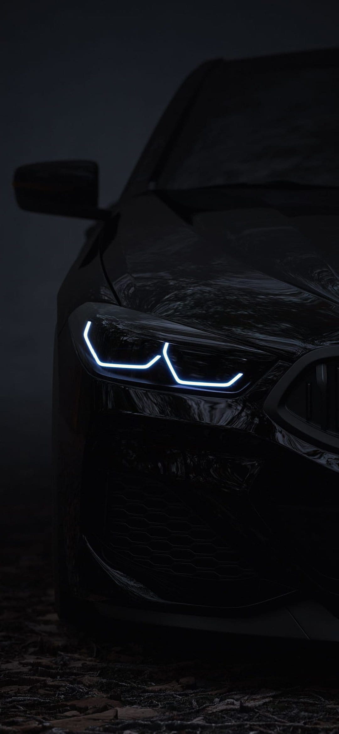 Modern car headlight with blue LED accents glows against a dark misty backdrop on a glossy black vehicle body.