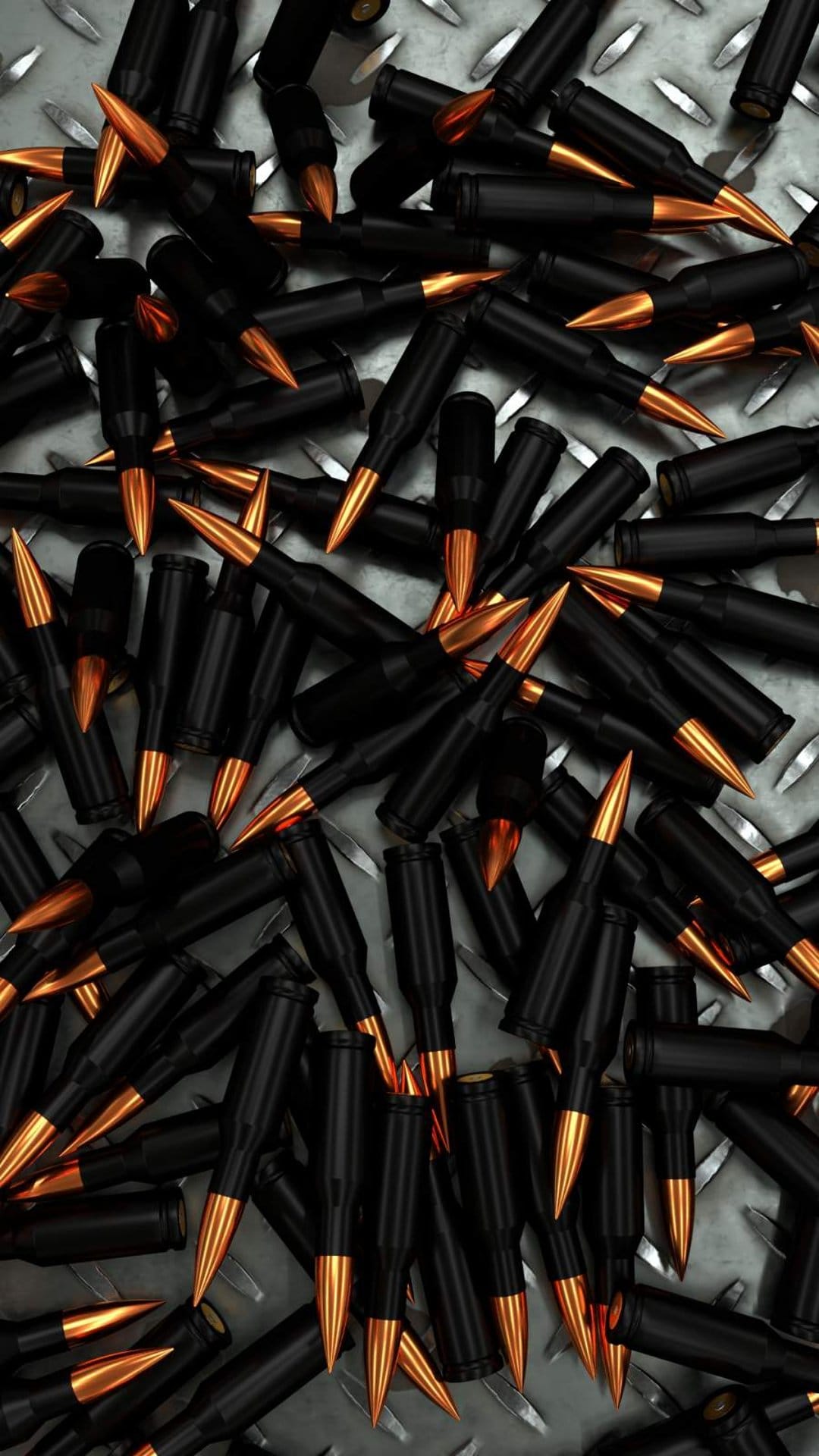 Black bullet casings with gold tips scattered across a textured silver diamond plate metal surface in macro view.