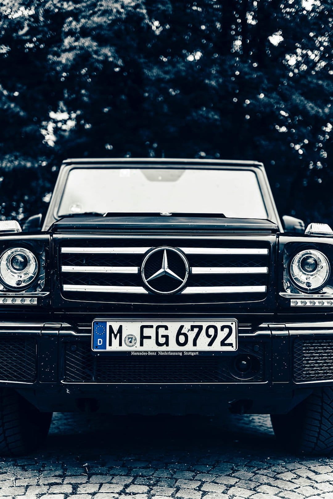 Black Mercedes G-Wagon front view featuring a chrome star emblem, LED headlights, and a German license plate.
