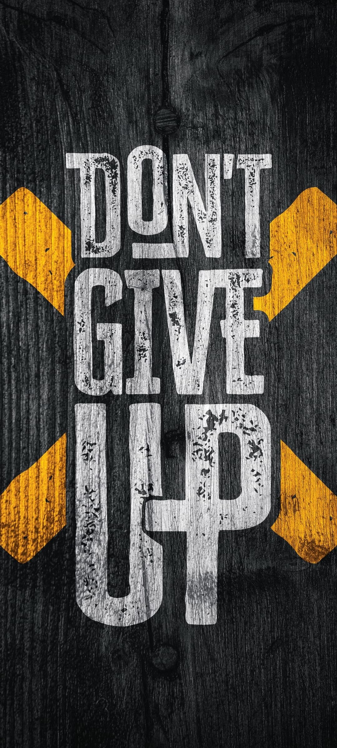 Don't Give Up quote in distressed white font on dark textured wood planks with yellow hazard-style stripes.