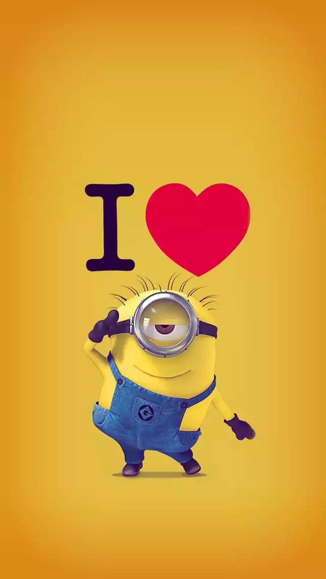 Minion wearing goggles and blue overalls stands under a large red heart graphic on a bright yellow background.