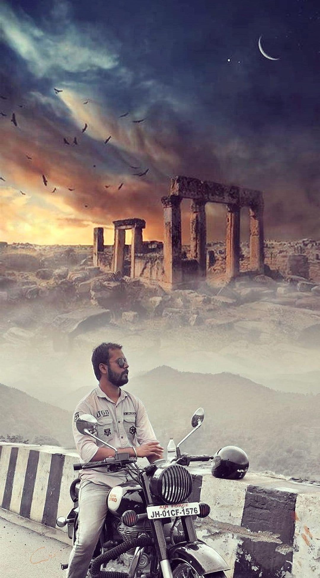 Biker in sunglasses sits on a vintage motorcycle facing crumbling stone ruins under a crescent moon sky.