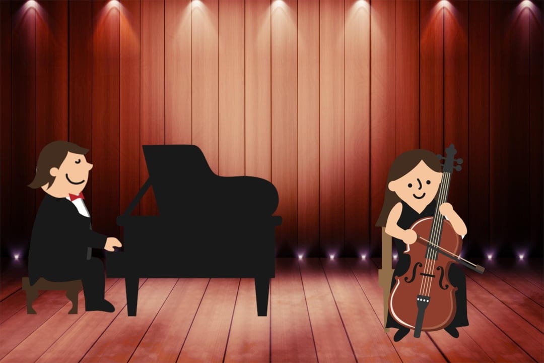 Pianist and cellist perform on a warm wooden stage illuminated by overhead spotlights during a musical recital.