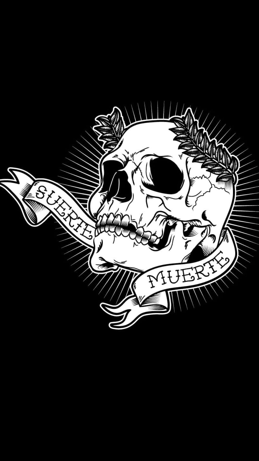Human skull wearing a laurel wreath between ribbons reading Suerte and Muerte with radiating light lines.