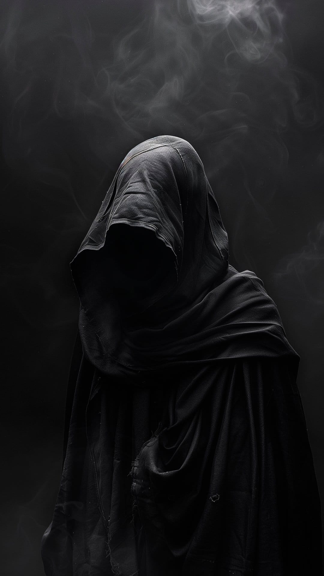 Hooded figure in a black cloak standing amidst gray smoke with hidden facial features and dramatic shadows.