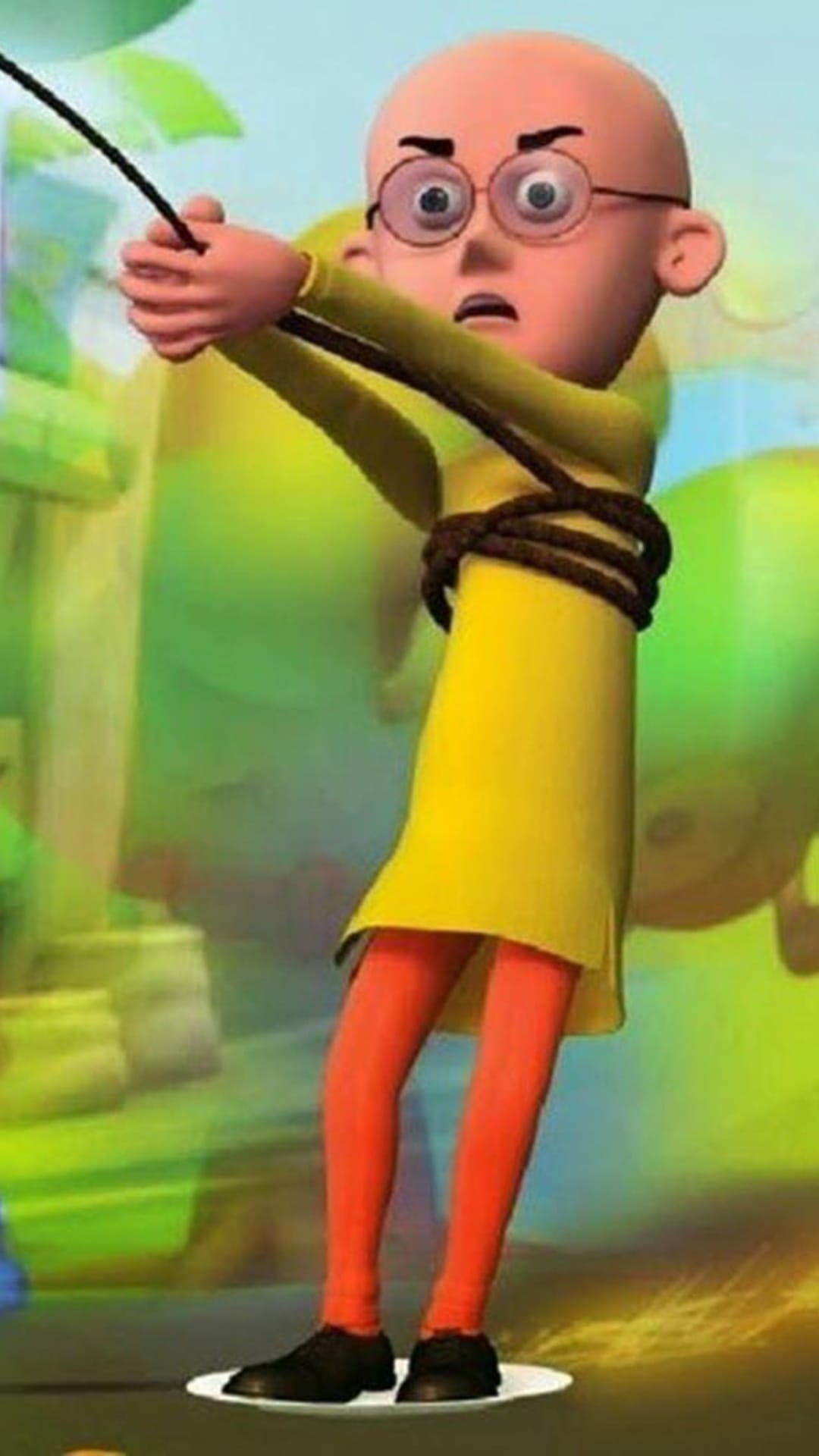 Bald boy wearing round glasses and a yellow tunic stands with his arms tied behind his back by a thick rope.
