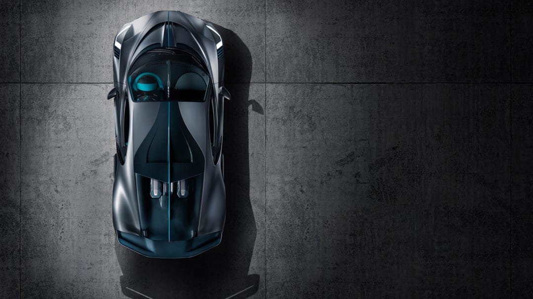 Bugatti Divo supercar seen from above on dark concrete with cyan accents and dramatic side shadows.