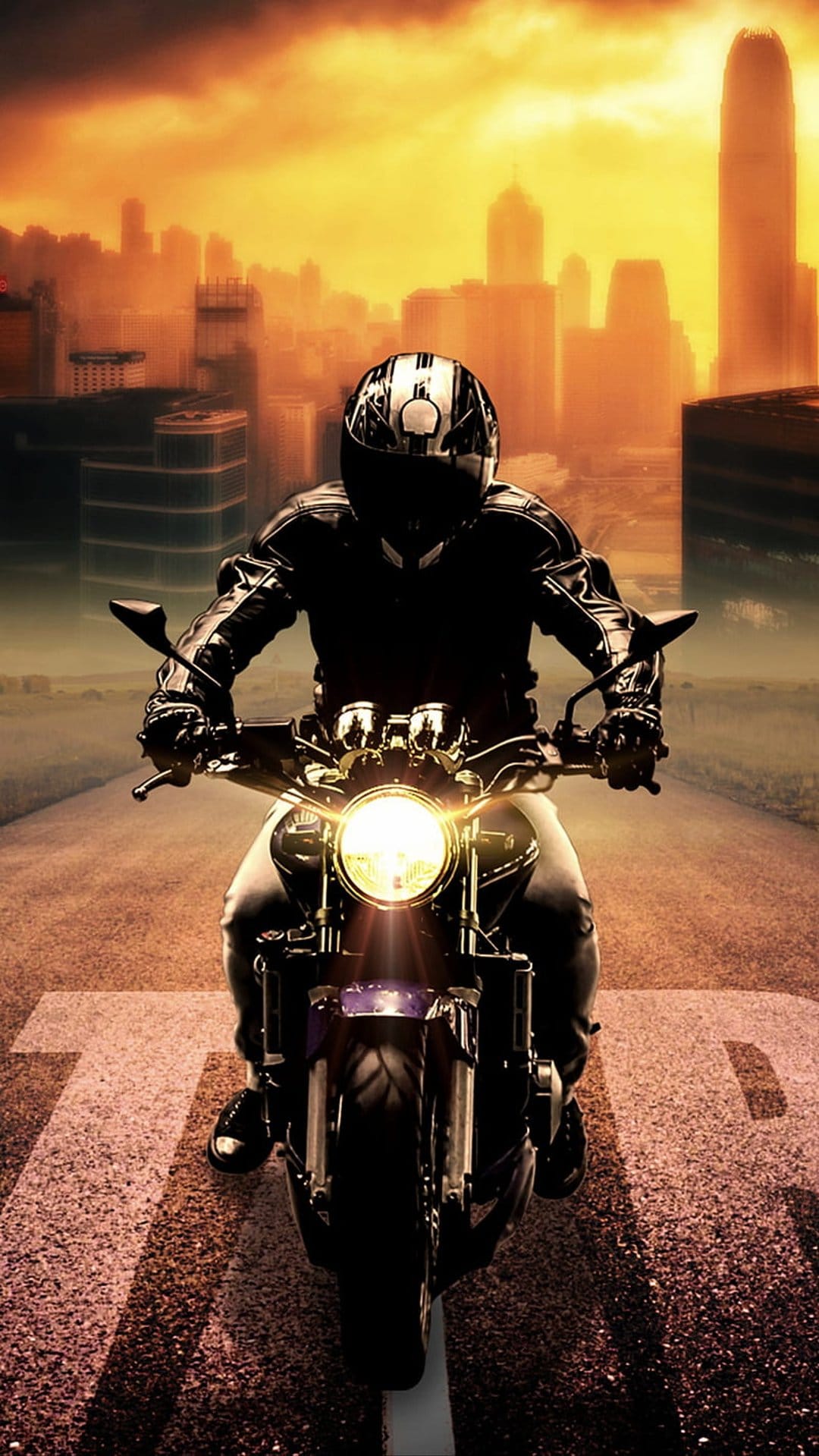 Motorcyclist in full gear rides on a highway during a fiery orange sunset with a hazy city skyline background.