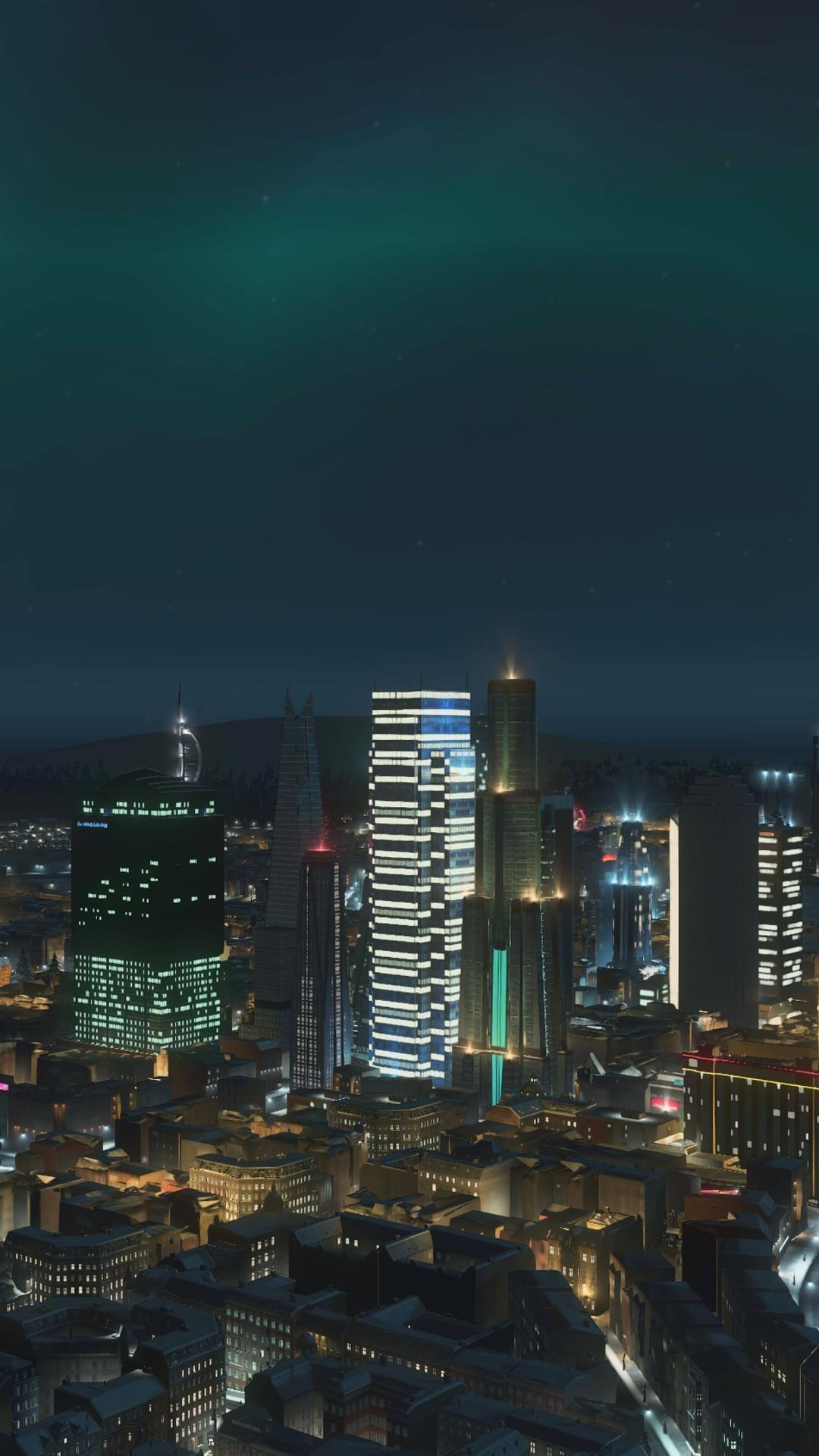 Glowing skyscrapers and lit office windows fill a dense urban grid under a dark night sky in a high-angle view.
