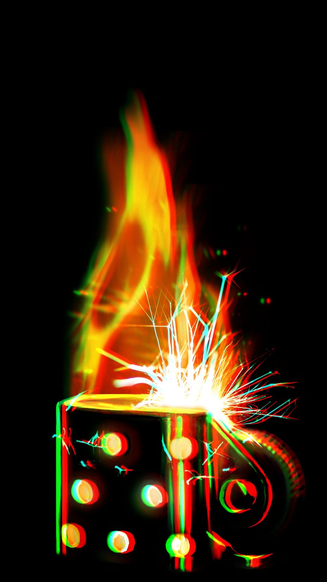 Black dice lighter emitting orange flames and colorful sparkles with a red and green 3D anaglyph shadow effect.