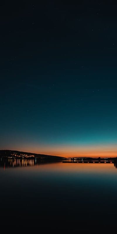 Night sky, Calm water, Reflection, Twilight, Serene, Lake, Starry, Orange horizon, Blue sky, Peaceful, Tranquil, Landscape, Evening, Water reflection, Outdoor, Scenic, Beautiful, Dusk, Stars, Riverside