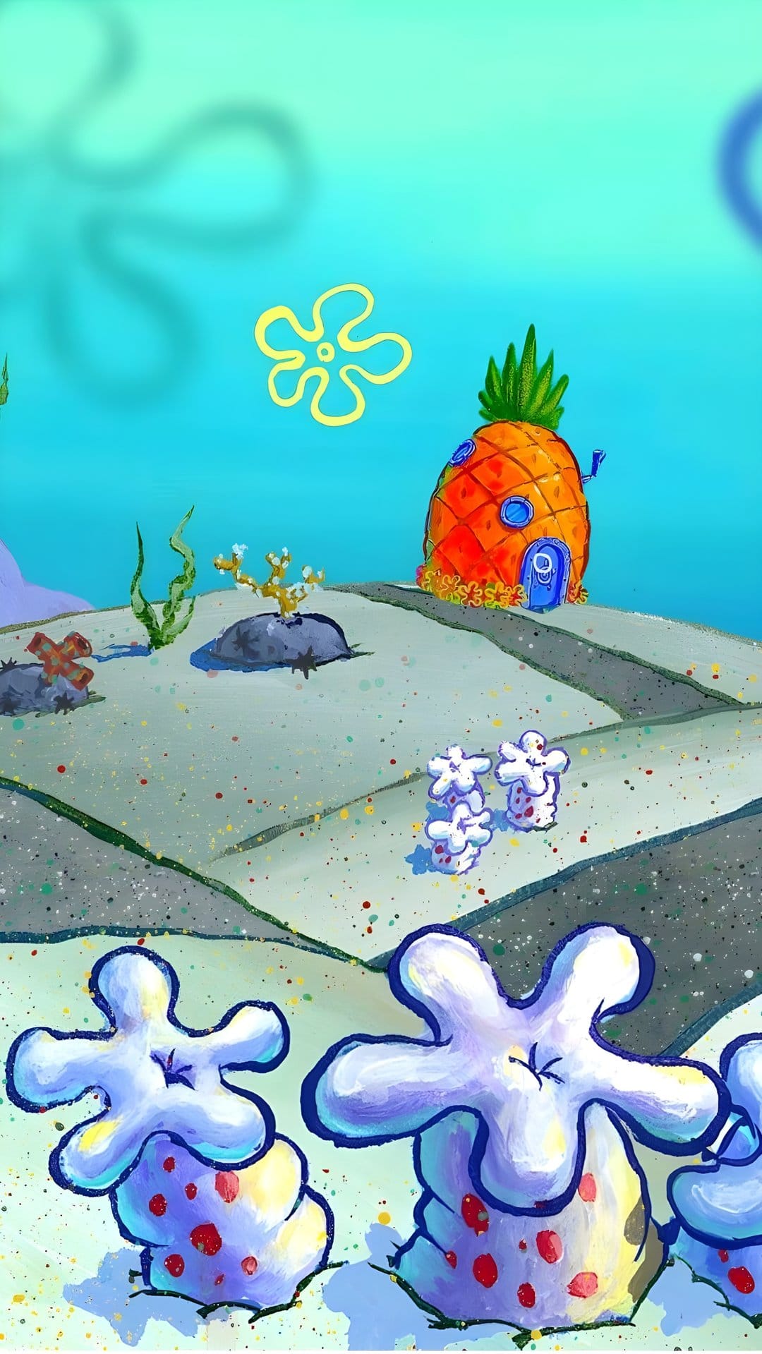 Pineapple house with a metal door and chimney stands on a sandy seabed surrounded by blue water and sea flowers.