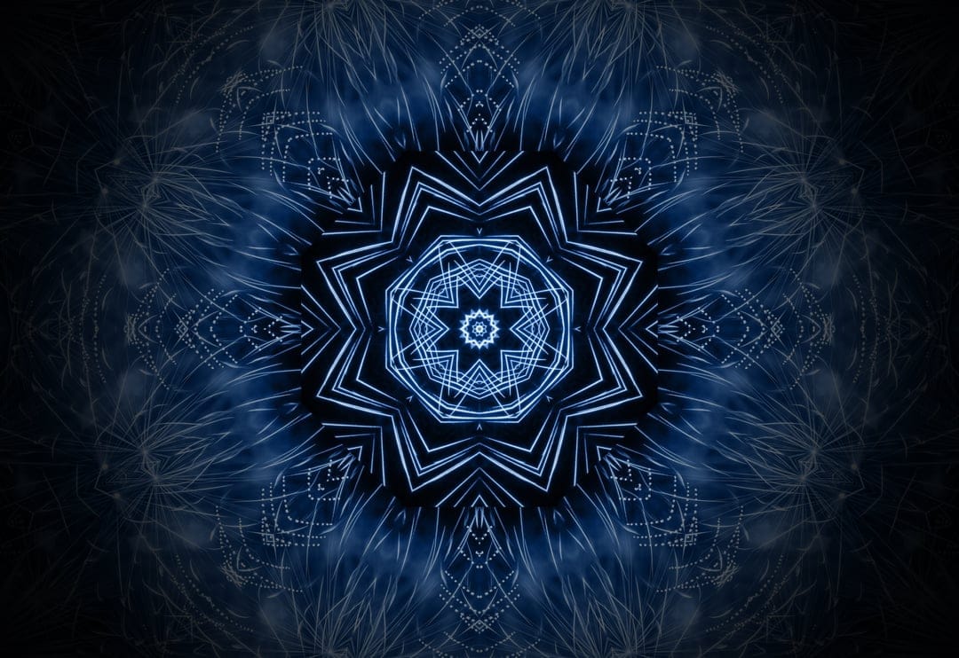 Luminous blue mandala with intricate geometric fractals radiating from a bright center against a dark background.