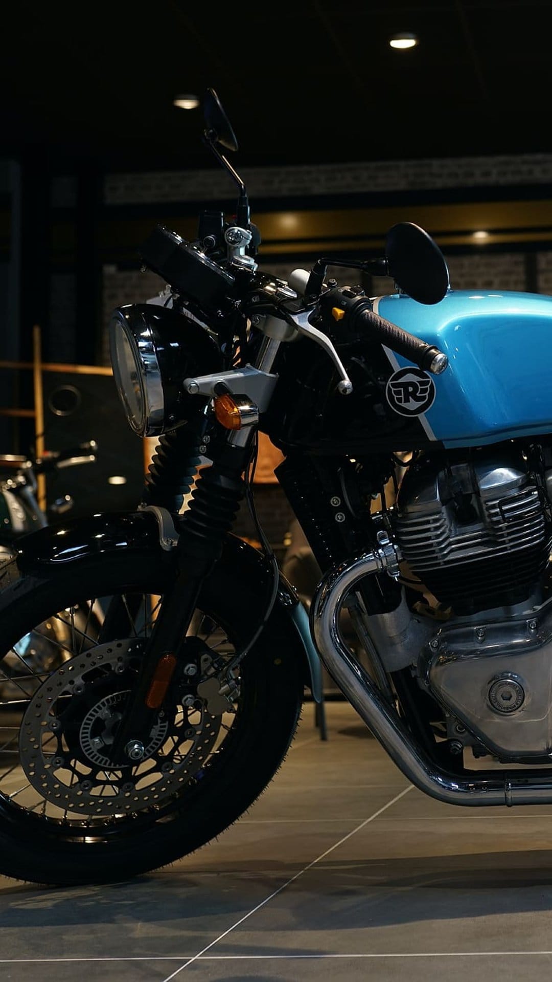 Royal Enfield Interceptor 650 motorcycle featuring a blue fuel tank, chrome engine parts, and front disc brake.
