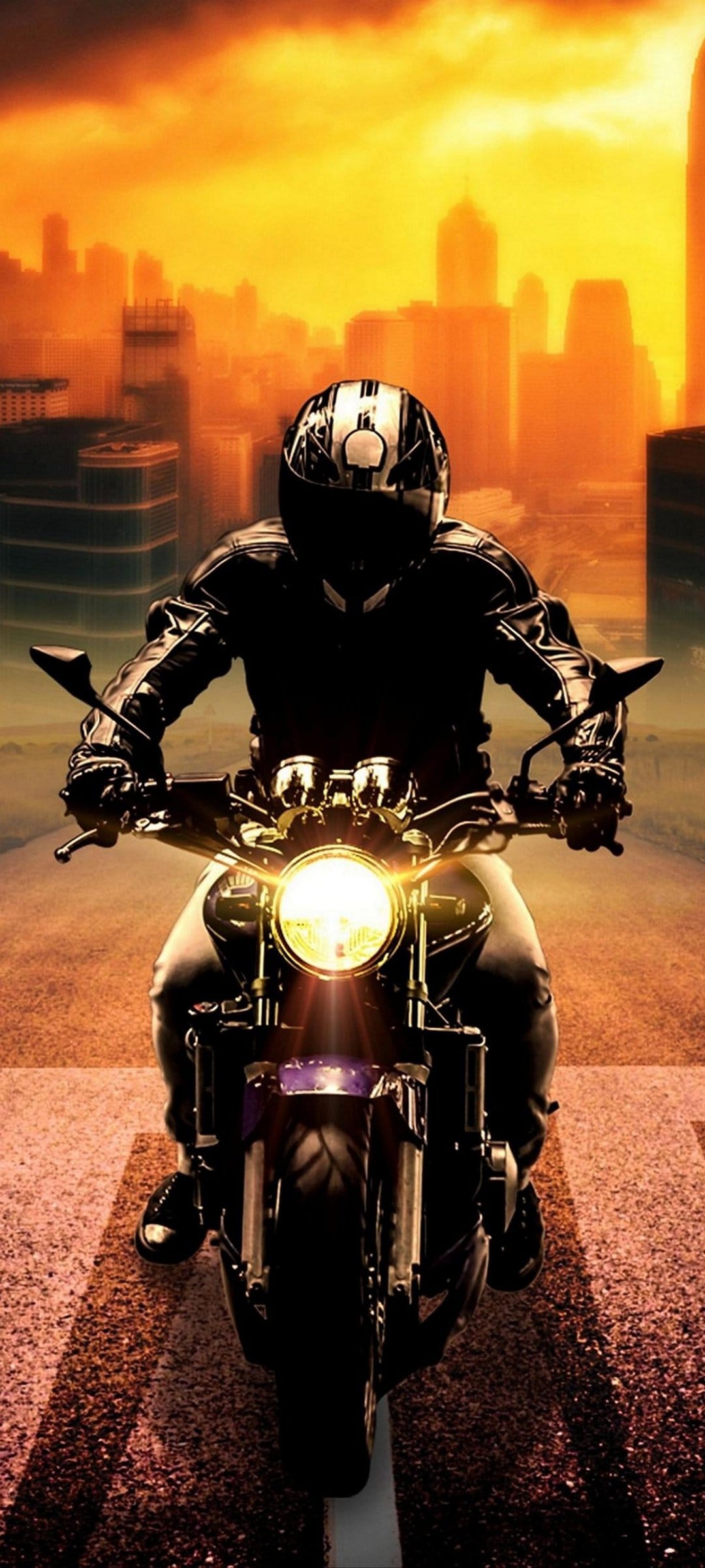 Motorcycle rider in black leather cruises toward a glowing city skyline during a golden hour urban sunset.