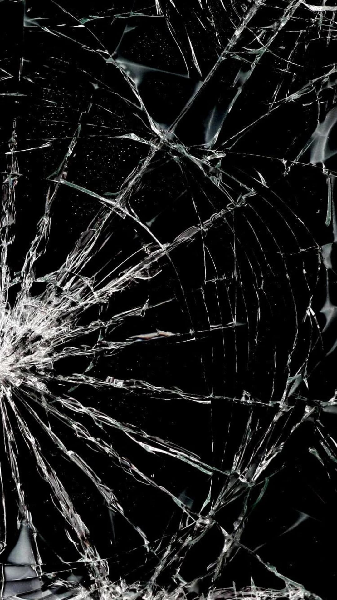Shattered black glass surface with intricate white cracks radiating from a central impact point on a dark background.