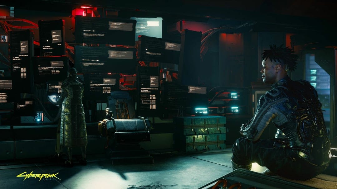 Man in tactical gear looks at glowing computer monitors in a dark red and cyan cyberpunk hacking den.