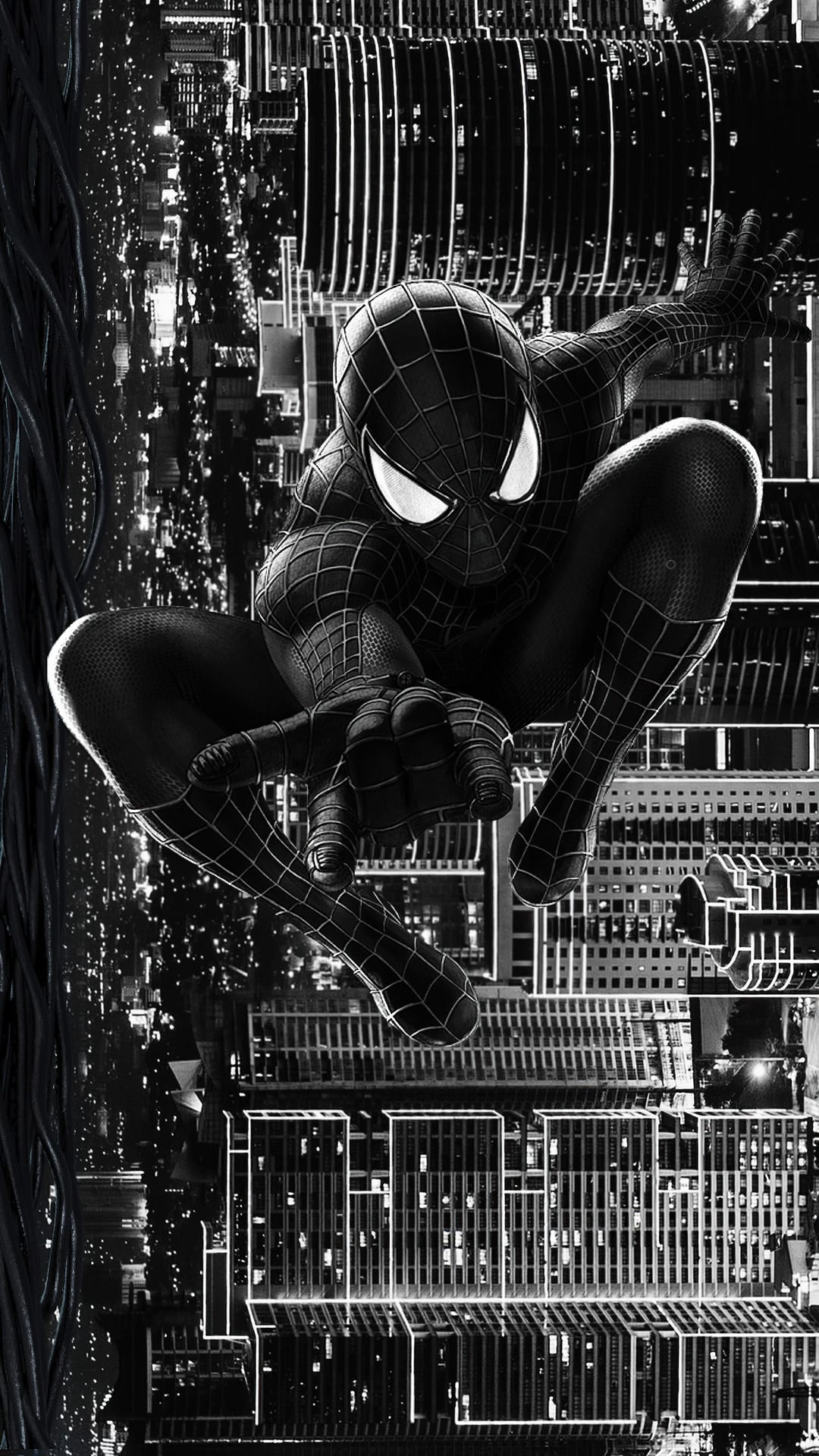 Spider-Man in a black suit leaps through a grayscale city at night with illuminated windows and skyscrapers.